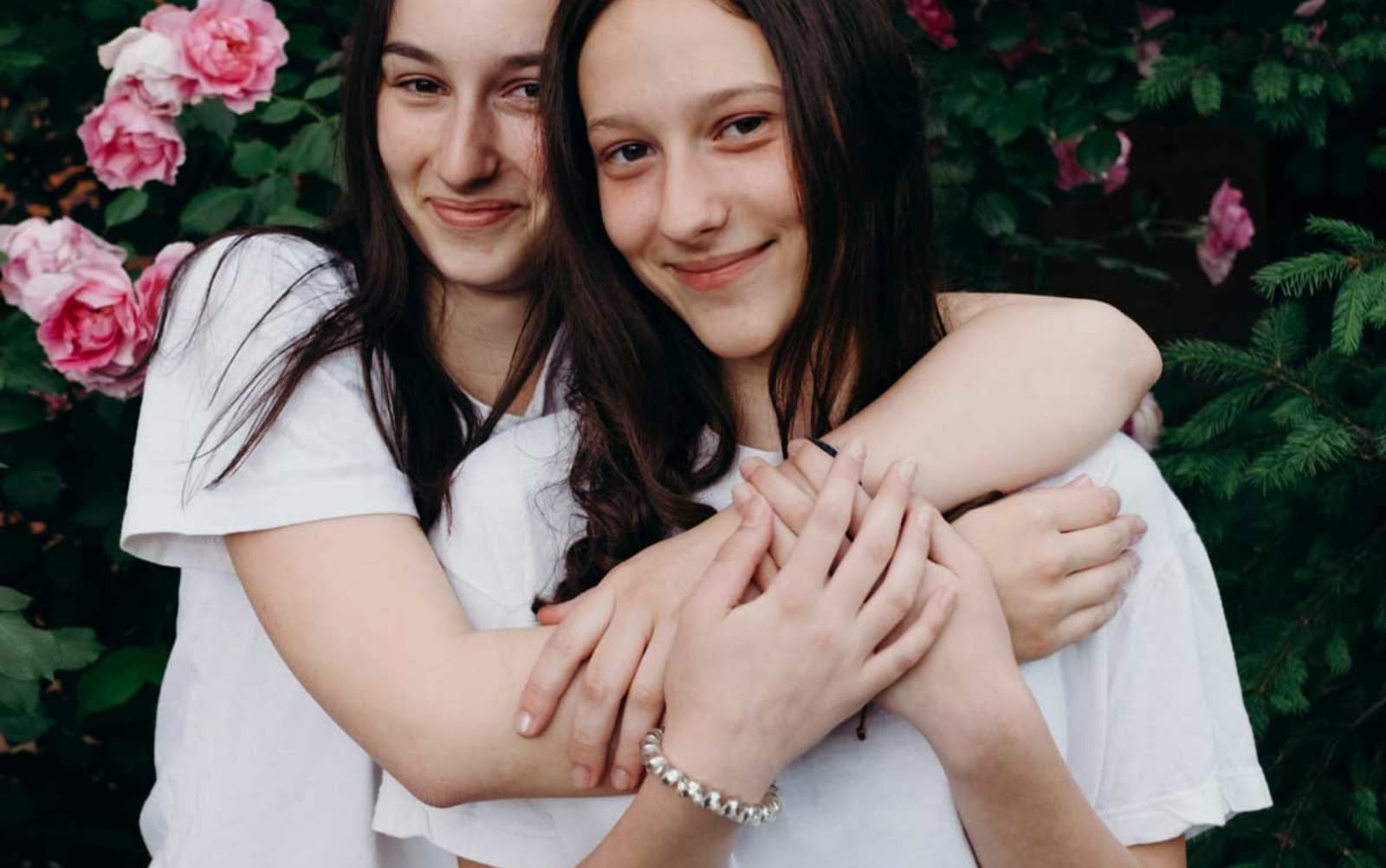 Two young women hugging each other in support